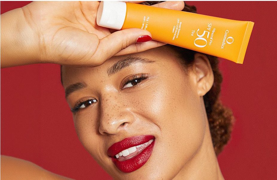 A woman holding Mineral Sunscreen SPF 50