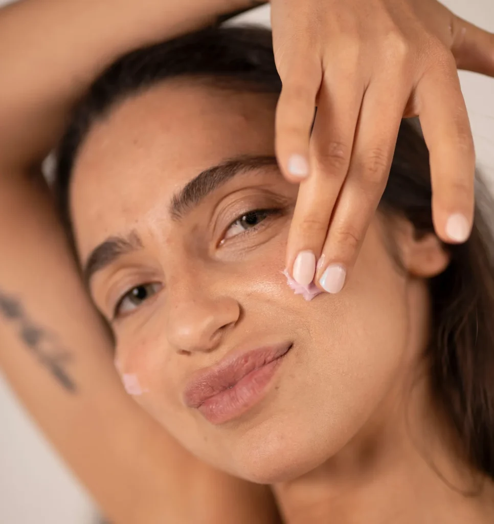 A lady applying O Cosmedic product onto her face - What to Expect When Using O Cosmedics