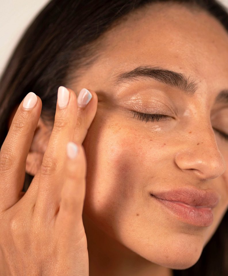 a-woman-layering-skincare-serum-on-her-face A woman doing the skin cycling regimen