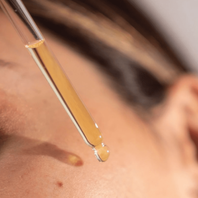 How to Use Retinol Serum | Woman applying drops of serum
